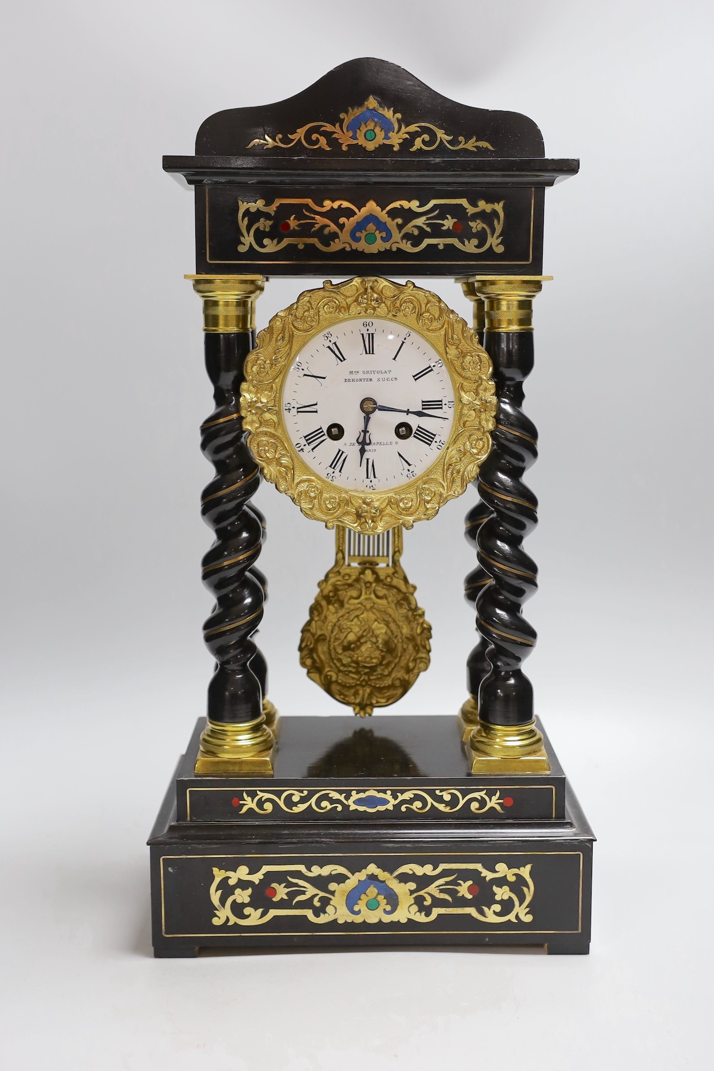 A French Napoleon III ebonised and brass inlaid portico clock. 49cm tall